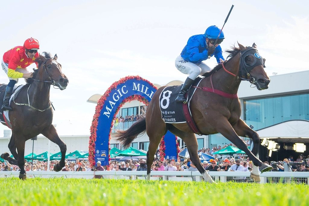 entertainment-on-gold-coast Thoroughbred horses racing past the Magic Millions finish arch at Broadbeach, showcasing live racing and premium entertainment on Gold Coast during summer events